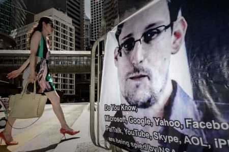 File picture: A woman walks past a banner displayed in support of former US spy Edward Snowden in Hong Kong on June 18, 2013. The 29-year-old former contractor for the National Security Agency dismissed allegations he was a traitor or a Chinese agent, and insisted he had exposed a dangerous US global surveillance network that threatens the privacy of millions. Photo - AFP / Lehtikuva.
