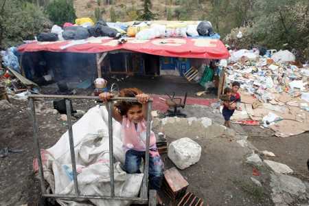 Syrian children refugees, who flock by dozens in Turkey each day, fleeing the civil war in their country, play on October 4, 2013 at a makeshift camp in Ankara, where they arrived three months ago. In the central public Dikmen valley park in front of the eyes of local authorities, they build a shanty town. There are here some 250 refugees from Aleppo (northern syria) and among them 80 children. Saying that they live in very poor conditions, the Syrian refuges collect paper from garbage to try and make ends meet. Syrian President Bashar al-Assad today warned Turkey it will