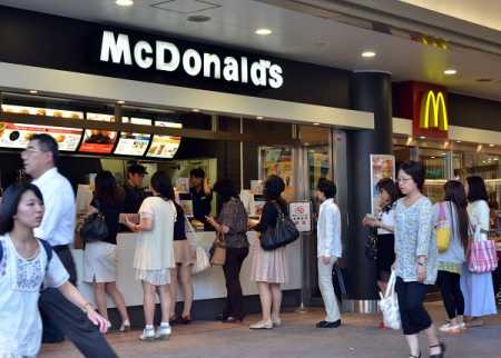 Customers order food at a McDonald's restaurant in Tokyo on July 25, 2014. McDonald's Japan said all of its Japanese restaurants had stopped selling products made with chicken from China, in the wake of a scandal that saw expired meat sold to fast food giants. More than 3,000 restaurants across Japan had also halted imports of chicken products from the country, the chain said, adding that it had switched to distributors in Thailand