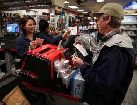 With the Jackpot now at 500 million, Sherrie Haines sells a Powerball ticket to Robert Sweeney at the BP gas station, January 6, 2015 in Dunkirk, Maryland. File Photo AFP-Lehtikuva.